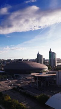 Aerial view of Altice Arena and Parque das Nacoes skyline on a cloudy day. Lisbon, Portugal. Vertical video