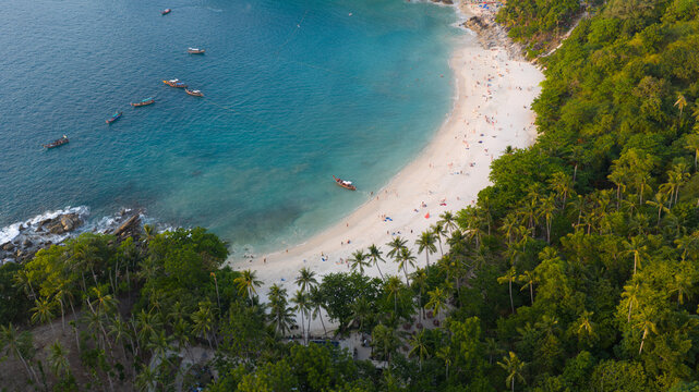 Aerial view of Freedom Beach with white sand, turquoise water, and longtail boats anchored near the shore in Tambon Patong, Chang Wat Phuket, Thailand.