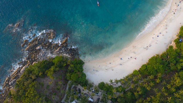 Aerial view of Freedom Beach featuring white sand, turquoise waters, and lush tropical vegetation along the rocky coastline in Tambon Patong, Chang Wat Phuket, Thailand.