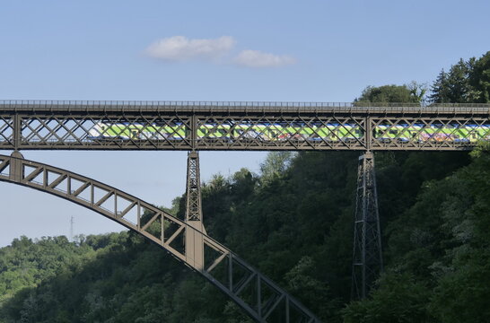 Train on San Michele bridge on Adda river, Lombardy, Italy