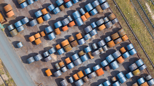 Aerial view of numerous blue and orange steel coils organized in rows at the Tata Steel industrial facility Velsen-Noord, Noord-Holland, Netherlands.