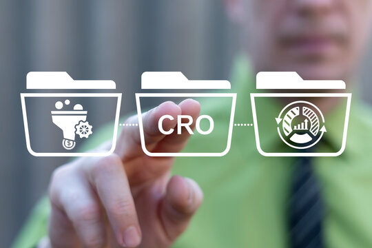Concept of CRO Conversion Rate Optimization. Business person using virtual touch screen presses the abbreviation CRO.