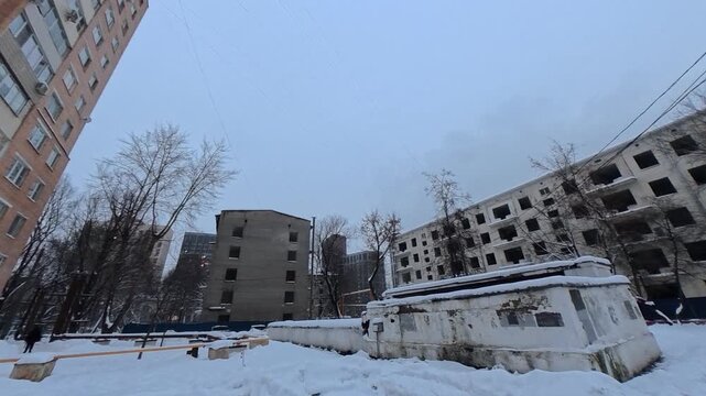 Abandoned apartment buildings ready for demolition in snowy urban landscape winter decay desolate architecture urban exploration