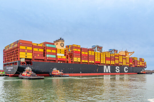Boston, MA, US-April 25, 2026: Large international cargo ships in harbor  loaded with shipping containers.
