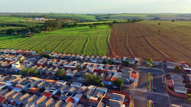 Aerial view of residential neighborhood with farmland and construction