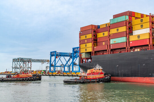 Boston, MA, US-April 25, 2026: Large international cargo ships in harbor  loaded with shipping containers.