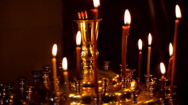 thin wax candles burn on stands