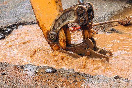 Construction crew works on water main break in street city