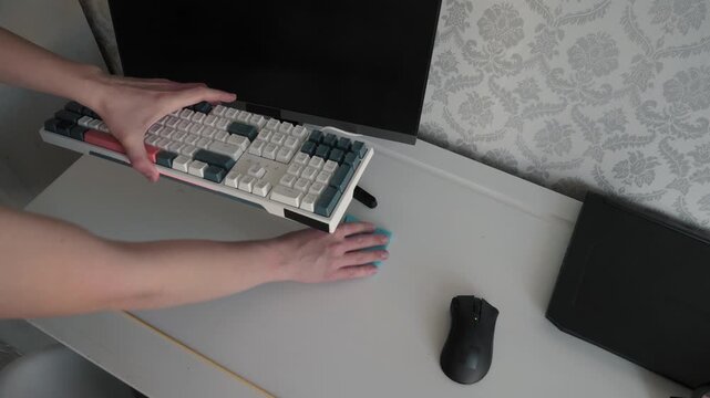 Cleaning workspace essentials. Maintaining tidy ergonomic computer station. Person sanitizing table with cloth at desk. Closeup of hands wiping desk setup in calm environment