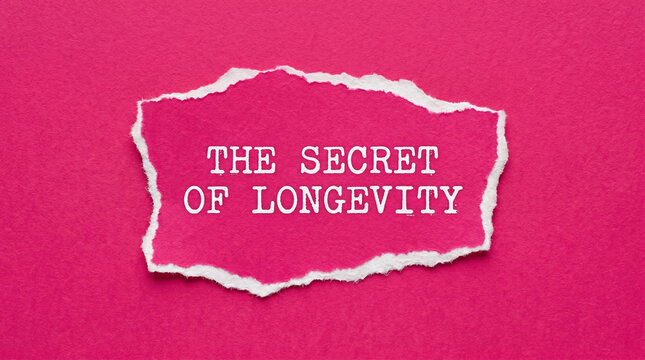 The secret of longevity text typed on torn white paper piece against bold pink background