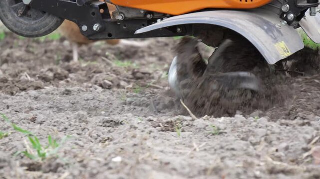 4K B-Roll Rototiller Tines Churning Dark Soil Outdoor Garden Bed Preparation Mechanical Equipment Action