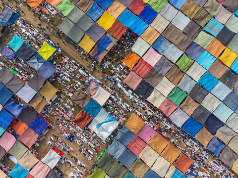 Tongi, Bangladesh - 31 January 2025: Aerial view of thousands of devotees gathered under colorful tarps for a religious congregation during the Bishwa Ijtema.