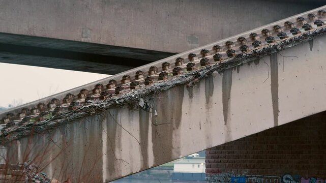Rubble of the collapsed Carola bridge (Carolabr&uuml;cke) in Dresden, Germany. Pulling focus on the reinforced concrete structure. Close-up of the damaged material on a rainy day.