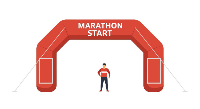 Man standing under a red inflatable marathon start arch.