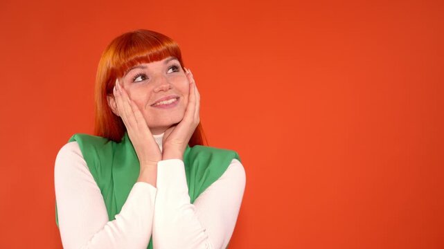 Woman shows different expressions with orange background in indoor setting during daytime