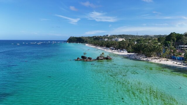 Malay, Philippines - 01 May 2026: Aerial view of Boracay Island featuring Willy's Rock, white sand beaches, turquoise waters, and palm trees under a clear blue sky.