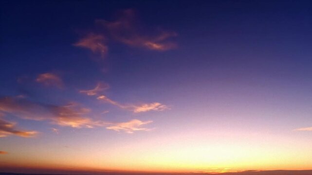 Vibrant sunset sky over distant horizon, soft clouds glowing in purple and orange light, serene natural background for travel and meditation themes