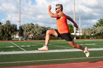 Fototapeta premium Sportsman jogger running. Man sportsman running for exercise. Sport athlete man run. Cardio workout. Runner at long sport run. Sportsman runner running outdoor. Sport run. Muscular man running
