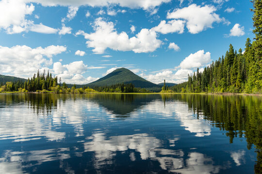 Canada, BC, Bowron Lake Provincial Park.  Devil's Club Mountain reflecting in the calm water of Swan Lake.