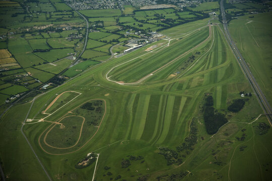 Waterford Regional Airport, Ireland - 02 July 2015: Aerial view of Waterford Airport runways and green airfield surrounded by lush countryside and a motorway.