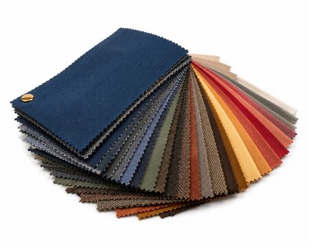 A rainbow of fabric swatches fanned out in a semi-circle, showcasing a spectrum of colors and textures for design inspiration