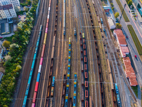 Prague, Czechia - 21 April 2026: Aerial view of a marshalling yard with colorful freight trains, cargo containers, and locomotives on multiple tracks.