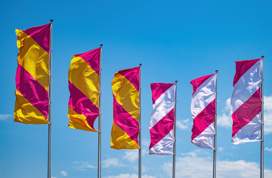 flags waving in the wind against blue sky