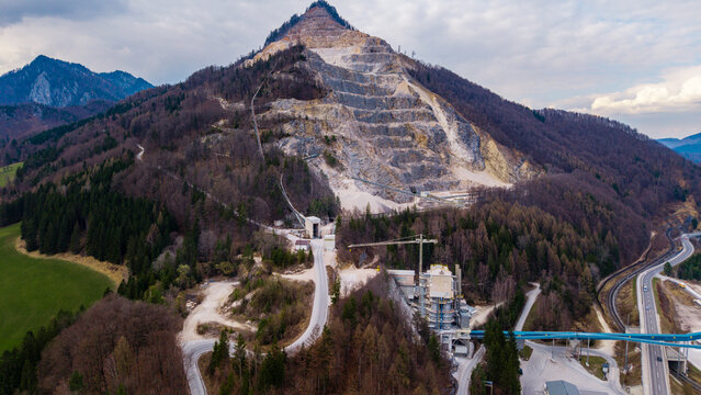 Klaus an der Pyhrnbahn, Austria - 23 March 2026: Aerial view of the VOEST Quarry with terraced mountain excavation, industrial facilities, and dense forest.