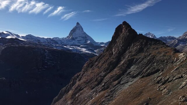 Aerial flyover over the Gorner glacier at Gornergrat in Zermatt, Switzerland with a paning view from Matterhorn to the icy crevasses and other tall mountain peaks