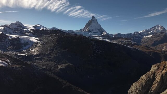 Aerial flyover over the Gorner glacier at Gornergrat in Zermatt, Switzerland with a pan down view from the Matterhorn to the icy crevasses