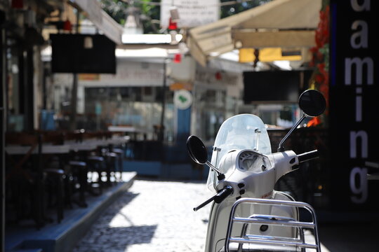 A white scooter parked on a street