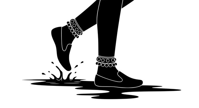 Silhouette of Indian legs with traditional anklets stepping into water puddle