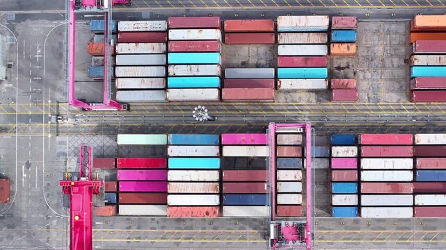 Witness the vibrant colors of shipping containers stacked high at a bustling cargo port. Cranes expertly move goods, orchestrating the flow of international trade and ensuring timely delivery.