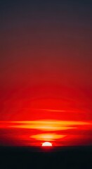 Fototapeta premium Intense red and fiery orange colors dominate the sky as the sun breaks the horizon, creating a spectacular natural dawn display, twilight, dramatic, backdrop