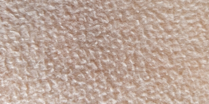 Soft beige terry cloth texture, macro view of fluffy cotton towel fabric, neutral cream textile background for spa and wellness branding
