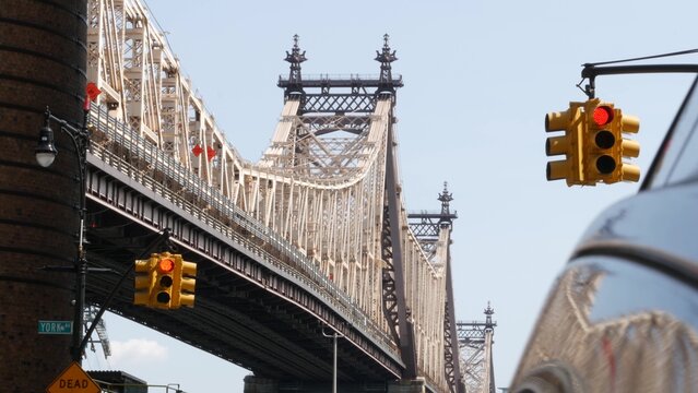 New York City Manhattan Midtown, Queensboro bridge architecture in United States. Urban transport bridge over East River. Yellow traffic light under metallic bridge in East Side. First 1st avenue.