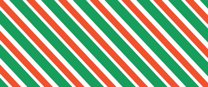 Christmas seamless pattern. Red and green diagonal stripes background. Candy cane repeating decoration wallpaper. Winter holiday lines backdrop. Xmas peppermint present wrapping print design. Vector