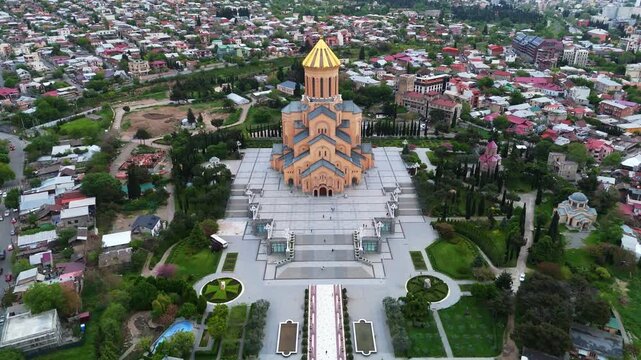 aerial drone view of the Holy Trinity Cathedral of Tbilisi (Sameba) at sunset. 