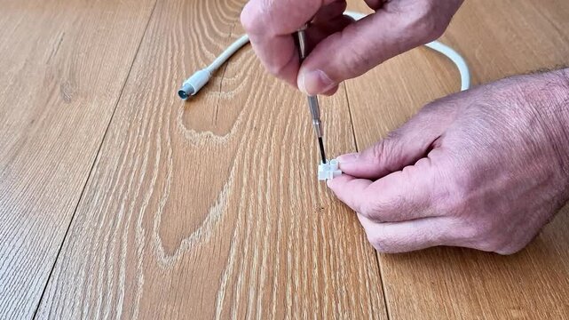 Save your tech with this quick DIY fix. Learn how to use a small screwdriver to repair a damaged charging cable connector and restore power. Easy, step by step home maintenance guide