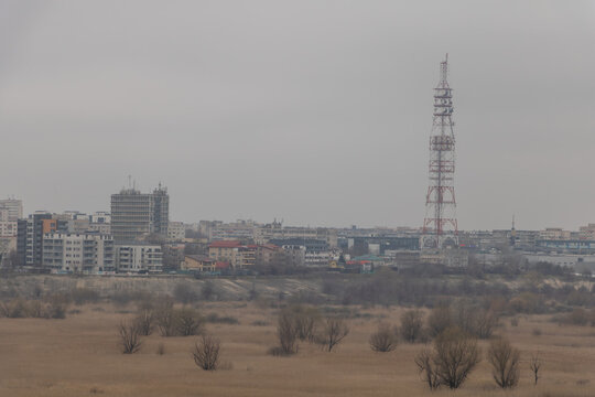 Communication tower and residential buildings seen from Vacaresti Nature Park in Bucharest - Urban industrial landscape