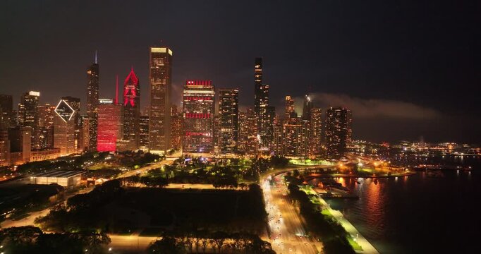  Aerial Night View of Chicago Downtown Skyline with Illuminated Skyscrapers and Lake Michigan, Illinois, USA on April 26 2026 
