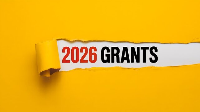 2026 grants text tearing through yellow paper background concept