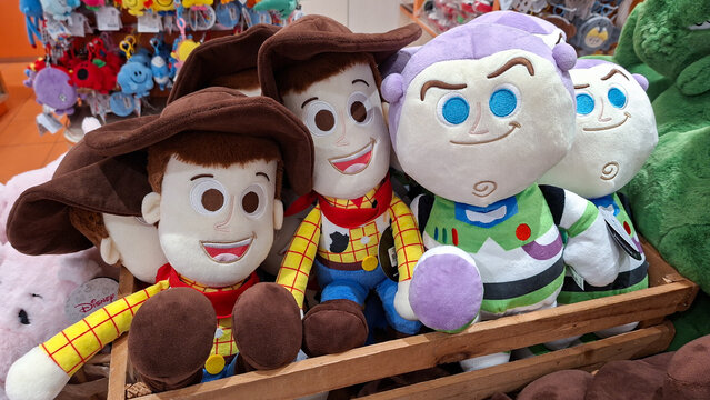 Colorful Woody and Buzz Lightyear plush toys sitting in a wooden crate display on May 9, 2026 in Bangkok, Thailand.