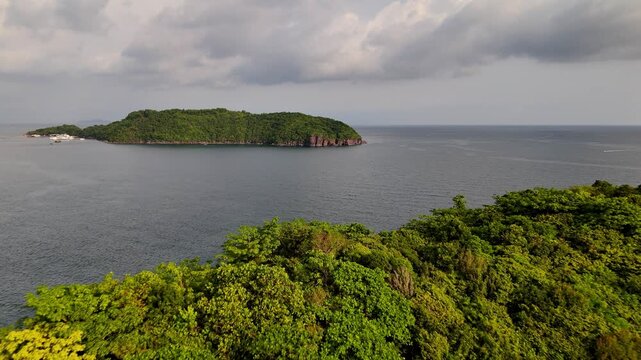 back panoramic pan view of Kim Quy island over looking M&acirc;y R&uacute;t Island in the evening after an evening rain.