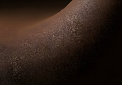 A rich, earthy brown textured surface artfully displays subtle pores and organic contours, suggesting natural material with compelling depth and luxurious tactile qualities