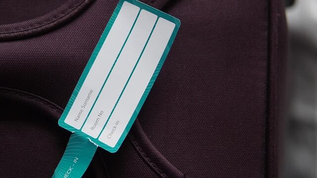 Bag tag shows your name and room details at hotel