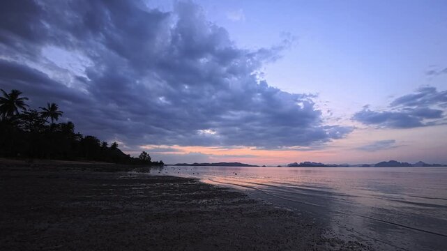 Low tide beach with reflective wet sand and distant island horizon