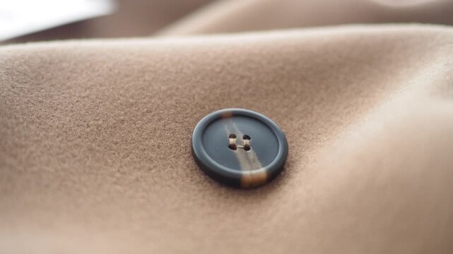 Close up of a button on fabric showing texture and design