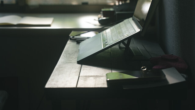 Laptop on Stand on Dark Wooden Desk Moody Work Setup