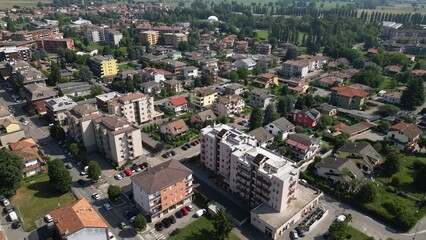 Fototapeta premium Urban Landscape: A stunning aerial view showcases a vibrant cityscape, with an intricate network of buildings and infrastructure seamlessly integrated into a thriving community. Pantigliate, Italy